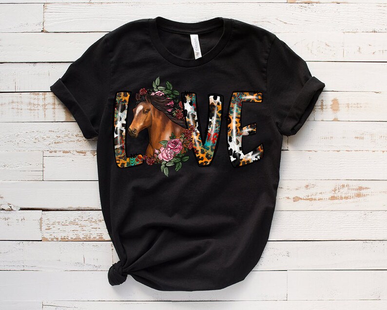 May include: Black t-shirt with a graphic of the word "LOVE" in colorful letters with a horse head and floral design.