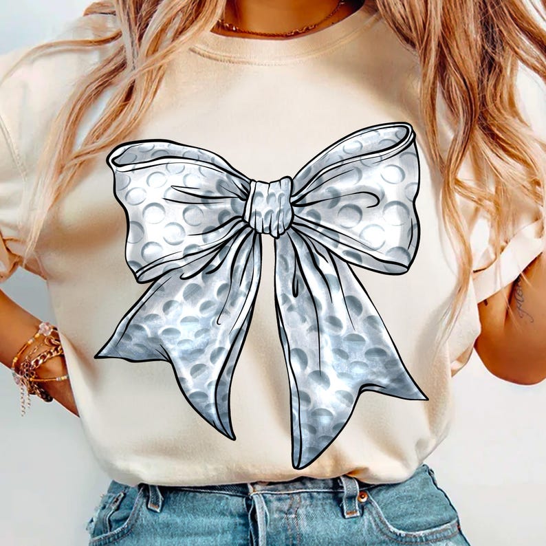 May include: A white t-shirt with a large silver bow printed on the front. The bow is made of bubble wrap material.