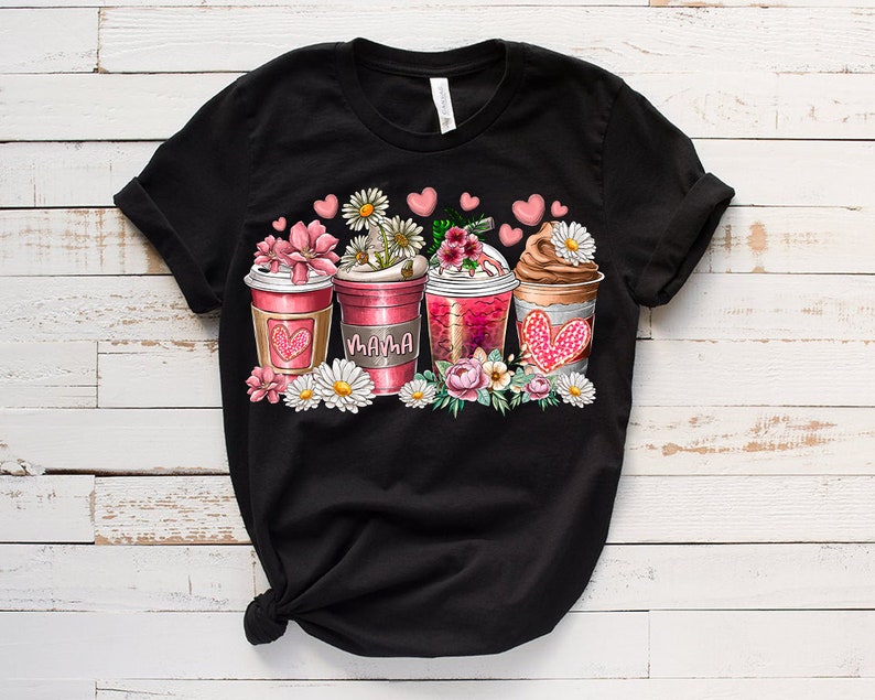 May include: Black t-shirt with a graphic of four coffee cups with flowers and hearts. The cups say "Mama" on one of them.