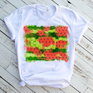 May include: White t-shirt with a watermelon print. The print is a green and red abstract design with black seeds.