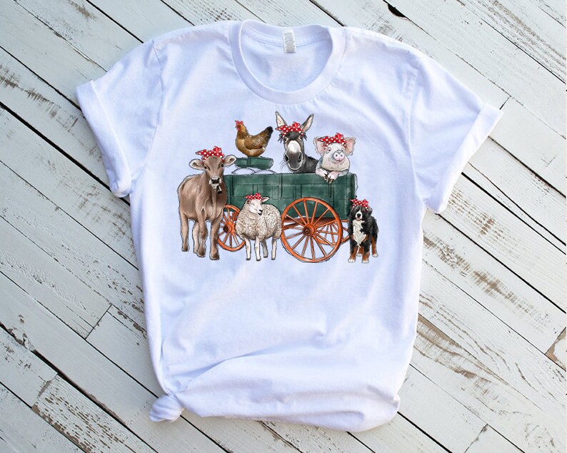May include: White t-shirt with a graphic of a farm scene. A cow, pig, donkey, chicken, sheep, and dog are all wearing red bandanas and riding in a green wagon.