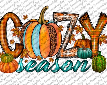 May include: A graphic design featuring the word "Cozy Season" in teal script with a pumpkin, leaves, and fall-themed letters. The letters are decorated with plaid, leopard print, and stripes.