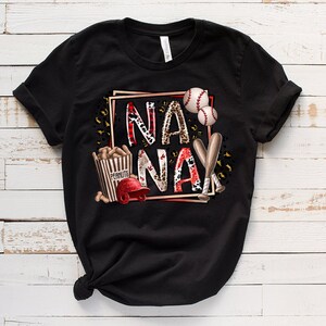May include: Black t-shirt with a graphic design featuring the words "NA NA" in a red and white leopard print, baseballs, bats, and a box of peanuts.