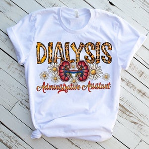 May include: White t-shirt with a leopard print design that says "Dialysis Administrative Assistant". The design also includes a pair of kidneys and white daisies.