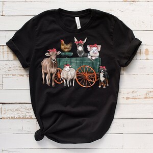 May include: Black t-shirt with a graphic of farm animals wearing red bandanas and riding in a wagon. The animals include a cow, a sheep, a donkey, a pig, a chicken, and a dog.
