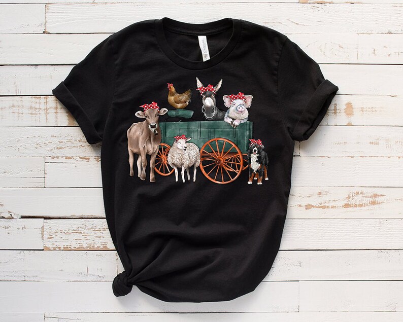 May include: Black t-shirt with a graphic of farm animals wearing red bandanas and riding in a wagon. The animals include a cow, a sheep, a donkey, a pig, a chicken, and a dog.