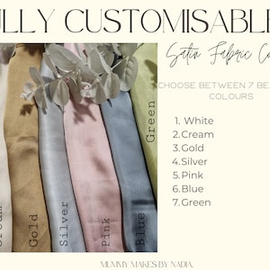 May include: Seven strips of satin fabric in white, cream, gold, silver, pink, blue, and green. The text reads FULLY CUSTOMISABLE, Satin Fabric Colours, CHOOSE BETWEEN 7 BEAUTIFUL COLOURS, 1. White, 2. Cream, 3. Gold, 4. Silver, 5. Pink, 6. Blue, 7. Green, MUMMY MAKES BY NADIA.