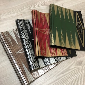 May include: Four vintage backgammon boards stacked on top of each other. The boards are made of wood and have a variety of patterns, including black and white stripes, red and gold stripes, and green and gold triangles. The top board has the word "RUSTIGO" printed on it.