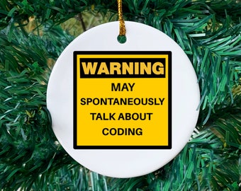May include: White ceramic ornament with a gold string for hanging. The ornament features a yellow and black warning sign that reads "WARNING MAY SPONTANEOUSLY TALK ABOUT CODING."