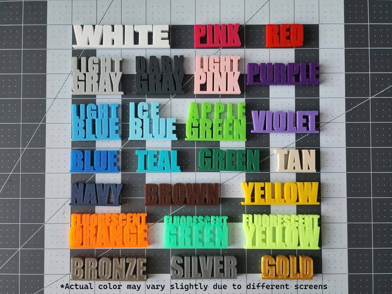 May include: A chart of 20 color swatches with the names of each color printed in white. The colors include white, pink, red, light gray, dark gray, light pink, purple, light blue, ice blue, apple green, violet, blue, teal, green, tan, navy, brown, yellow, fluorescent orange, fluorescent green, and fluorescent yellow. The chart also includes bronze, silver, and gold.