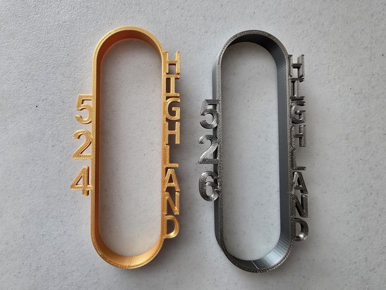 May include: Two metal keychains, one gold and one silver, with the word "HIGHLAND" and the numbers "524" and "526" printed on them.