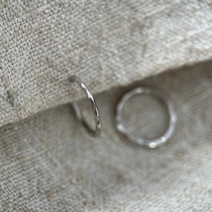 9ct solid white gold 9mm internal diameter delicate  textured huggie hoops. Sold as single or pair.
