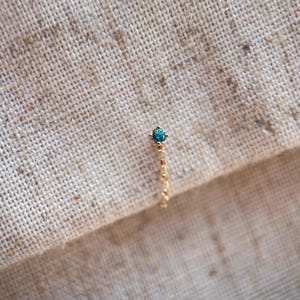 Genuine paraiba tourmaline ear stud with chain set in 9ct yellow gold. One single stud.