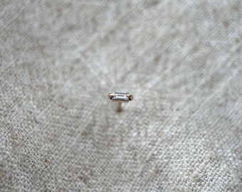 Tiny genuine baguette diamond ear stud in solid yellow gold. Single earring.