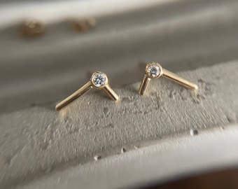 Genuine diamond and solid 9ct gold ear bar studs. Sold as a pair. Curated ear