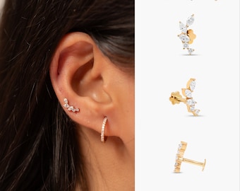 May include: A close-up of a person's ear with a small diamond earring in the helix piercing and a larger diamond hoop earring in the lobe. The image also shows three different styles of diamond earrings, each with a curved design.