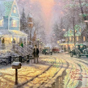 May include: A winter scene painting by Thomas Kinkade depicts a snow-covered street with vintage cars, houses, and figures. The artwork features a man with a dog, a mailbox, and sparkling glitter accents, evoking a nostalgic holiday atmosphere.