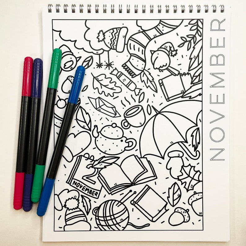May include: A black and white coloring page with a November theme. The page features a variety of fall-themed illustrations, including a teapot, a book, a cup of coffee, a scarf, a hat, and leaves. The page is numbered for easy coloring.