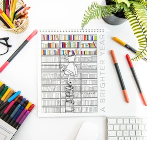 May include: A black and white coloring book with a girl climbing a stack of books in a library. The book cover says "A Brighter Year".