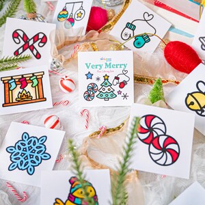 May include: A collection of square cards featuring colorful Christmas-themed illustrations including a nutcracker, candy canes, stockings, a snowflake, a bird, and peppermint candies. The center card displays the text Very Merry Mini Coloring Book.