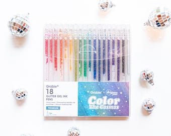 May include: A set of 18 Grabie Glitter Gel Ink Pens in a rainbow of colors. The pens are packaged in a clear plastic case with a colorful design. The text on the packaging reads "Grabie Color the Cosmos".