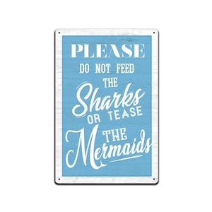 May include: A blue and white metal sign with the text "PLEASE DO NOT FEED THE SHARKS OR TEASE THE MERMAIDS".