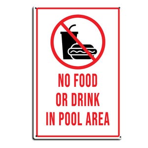 May include: A rectangular white sign with a red border featuring a red circle with a diagonal line through a black graphic of a cup and a hot dog. Below the graphic, the text reads NO FOOD OR DRINK IN POOL AREA in bold red capital letters.