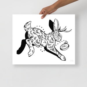 May include: Black and white line art illustration of a rabbit with antlers running with a pocket watch attached to its neck.