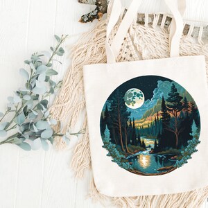 May include: A white tote bag with a circular design featuring a moonlit forest scene. The design includes a full moon, trees, a river, and stars in the night sky.
