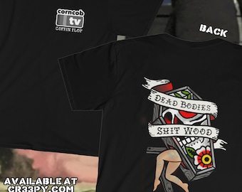May include: Black t-shirt with a white graphic of a coffin with the text "Dead Bodies Shit Wood" and a red rose. The front of the shirt has a white graphic of a television with the text "corncob tv" and "Coffin Flop".