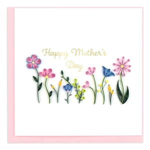 May include: A white card with a pink border and the text "Happy Mother's Day" in gold lettering. The card is decorated with colorful paper flowers.