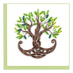 May include: A brown paper quilled tree with green leaves. The tree is curled into a circle shape with the branches and leaves extending outward.