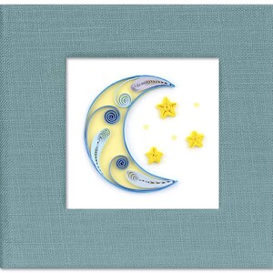 May include: A blue and yellow paper quilled crescent moon with five yellow paper quilled stars on a white background.