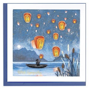 May include: A greeting card with a blue border features a night scene with floating lanterns. A person in a boat releases a lantern over a lake. The text "With Sympathy" is written in gold script at the bottom of the card.