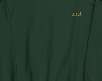 May include: A dark green sweatshirt with the word ",and" embroidered in gold on the front.