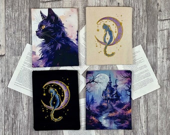 May include: Four different designs of black cat themed fabric covers. The first cover features a black cat with yellow eyes against a purple and blue starry sky. The second cover features a black cat sitting on a crescent moon with stars and a purple glow. The third cover features a black cat sitting on a crescent moon with stars and a gold glow. The fourth cover features a black silhouette of a haunted house with a full moon in the background.