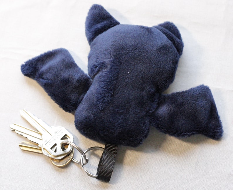 The back of the keychain is a solid dark blue minky fabric.