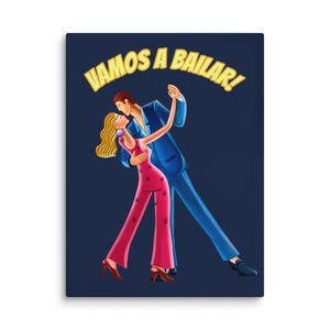 May include: A canvas print featuring a stylized illustration of a dancing couple. The man wears a blue suit, and the woman is in a pink jumpsuit. The text "VAMOS A BAILAR!" arches above them in yellow. The background is a deep blue.