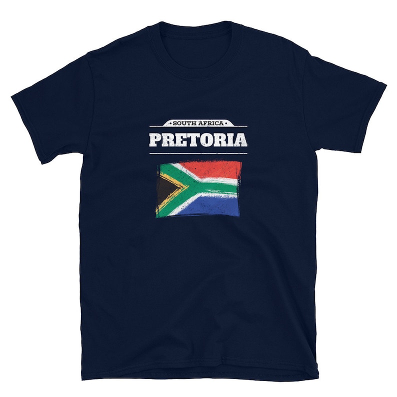 May include: Navy blue t-shirt featuring the text "SOUTH AFRICA PRETORIA" above a distressed South African flag design. The shirt is a short-sleeved crew neck.