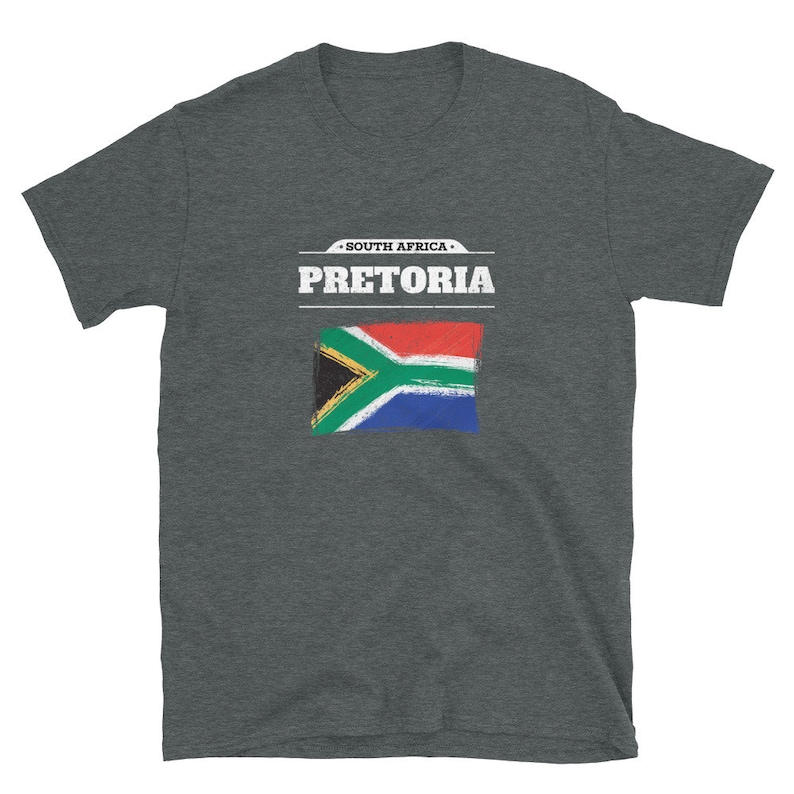 May include: Dark gray t-shirt featuring the text "PRETORIA" above a painted South African flag. The text "SOUTH AFRICA" is above the city name. The shirt is a short-sleeved crew neck.