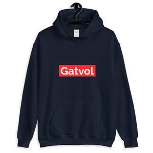 May include: A navy blue hoodie with a red box and the word "Gatvol" in white letters.