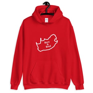 May include: Red hooded sweatshirt with a white outline of the map of South Africa and the text "Born & Bred" in white.