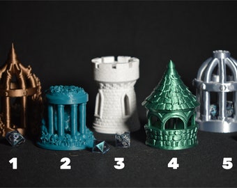 May include: Five different 3D printed miniature towers in various colors, including bronze, teal, white, green, and silver. Each tower has a unique design and is accompanied by a clear, multi-sided dice.