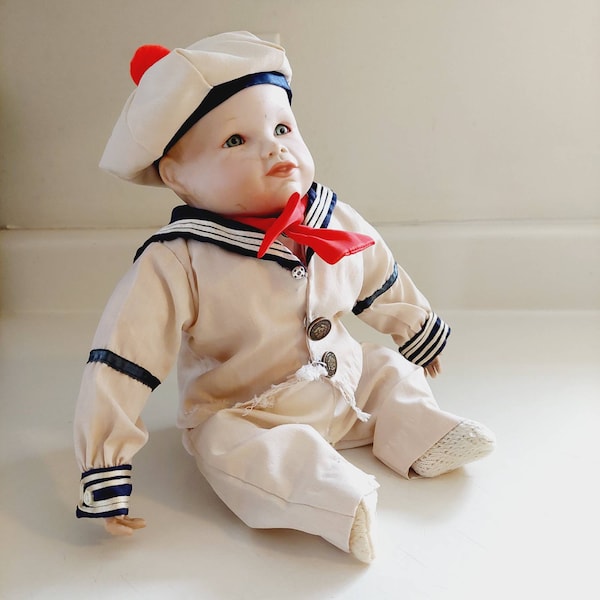 Vintage 1971 B Yolanda Bello Porcelain Cloth Baby Doll, Edwin M Knowles. Baby Boy in a Cream Sailor Suit with a Red Bolo Tie and Beanie Cap