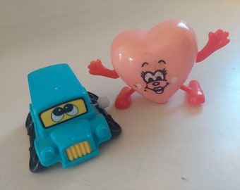 Vintage Set of 2 Windup Walking Toys. One Blue Car that sits up on it's wheels when in motion and a Walking Pink Heart. Both in fully functi