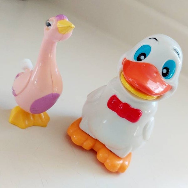 Vintage Set of 2 Plastic Easter Windup Toys. The white chicks winds up and rolls but does not walk forwards without help. The pink goose win