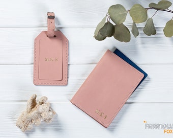 May include: Two pink leather travel accessories with gold lettering. A luggage tag with the initials "M.K.S." and a passport holder with the same initials.