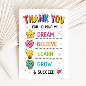 May include: A white card with the words "THANK YOU" in colorful letters. Below, it reads "FOR HELPING ME" and features illustrations of a star, heart, lightbulb, and globe, with the words DREAM, BELIEVE, LEARN, GROW, and & SUCCEED!