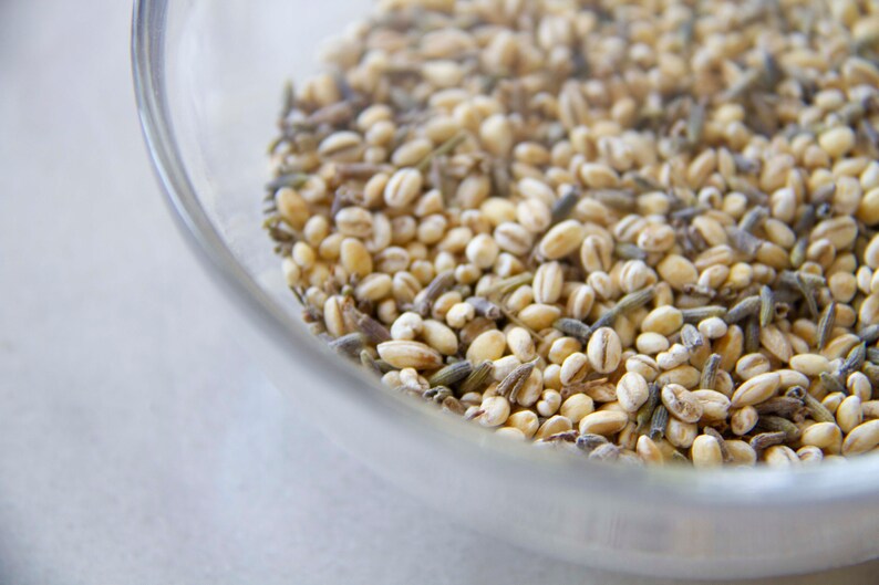 A macro image of a mixture of organic pearl barley and French lavender, used to fill lavender scented weighted yoga eye pillows.