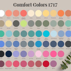 May include: A color chart titled Comfort Colors 1717 displaying sixty circular swatches in various shades including white, melon, terracotta, salmon, ivory, banana, citrus, mustard, orange, yam, khaki, butter, pepper, kiwi, grey, sage, hemp, bay, moss, and reef.